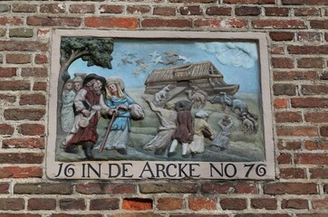 Historic Stone Tablet Depicting Noah's Arc on a Brick Wall in Amsterdam, Netherlands