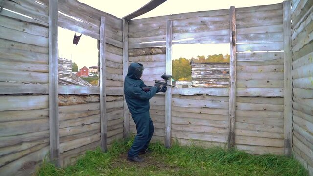Paintball. A war game with shooting balls. People are shooting with air guns. Paintball zone
