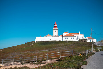 Fototapeta na wymiar Lighthouse on portuguese Farol de Cabo da Roca near Sintra, Portugal.