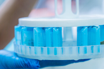 Laboratory assistant works with microwave hybrid tissue processor at the modern laboratory.
