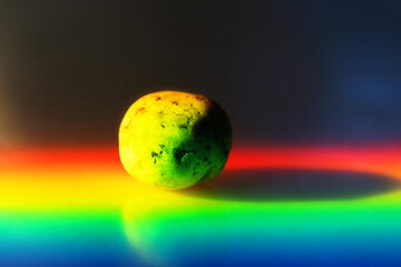 Zen stone in touch of rays of color.