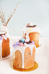 Traditional Easter cake sweet bread kulich decoratedwith candies. sugar flower, meringue icing
