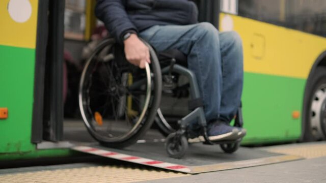 Person with a physical disability leaves public transport with an accessible ramp