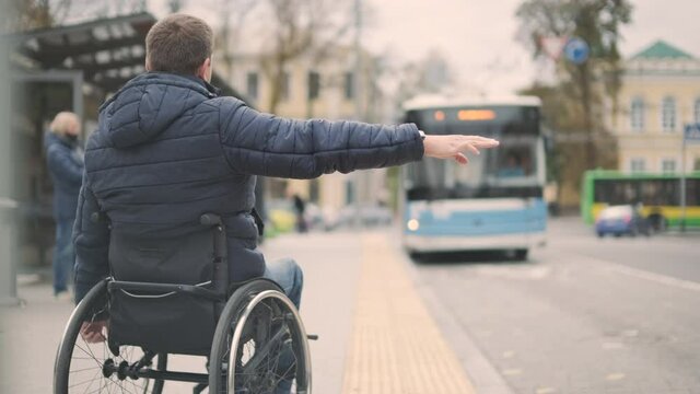 Person with a physical disability stops public transport with an accessible ramp