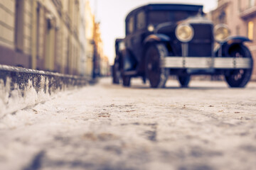 Winter in the city. The car is parked at the sidewalk. Antique car. Historical center of the city....