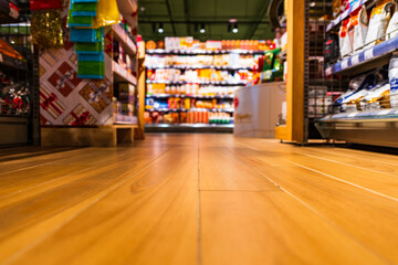 Grocery store. In the mall. Go shopping. Shelves with various goods. Product selection. Daily worries. The era of consumption. Focus on the floor. Close-up view from the level of the floor tiles.