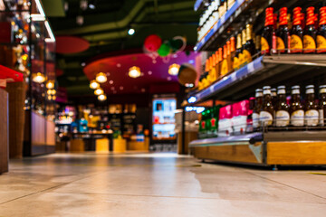 Grocery store. Alcohol section. In the mall. Go shopping. Product selection. Daily worries. The era of consumption. Focus on the floor. Close-up view from the level of the floor tiles.