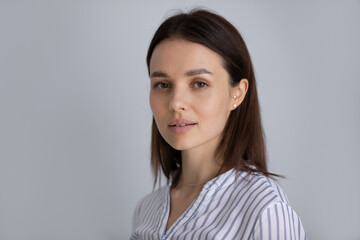 Portrait of beautiful young millennial Caucasian girl looking at camera. Positive pretty female model, woman, student posing isolated at white studio background. Head shot, profile picture