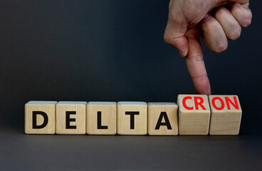 Covid-19 delta and deltacron symbol. Doctor turns cubes and changes the word delta to deltacron....