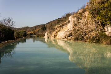 Natural swimming pool with thermal spring water in Bagno Vignoni, Italy.