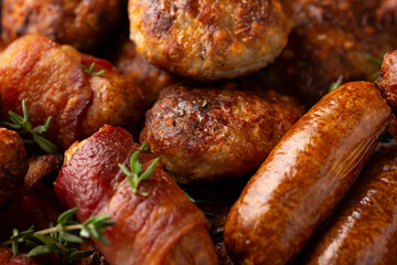 Pigs in Blankets, cocktail sausages and meatballs on plate. Party food