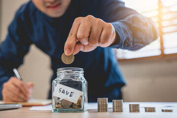 the person putting coin into piggy bank to save money and invest for growth in future.