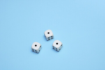 three dice with the same dropped out numbers lie on a blue background