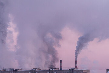 Fototapeta na wymiar industrial chimneys with heavy smoke causing air pollution