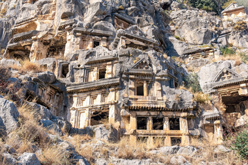 Obraz premium ruins of a rocky necropolis with stone-cut tombs in Myra Lycian (now Demre, Turkey)