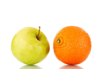 One juicy green apple and tangerine, close-up, isolated on white.