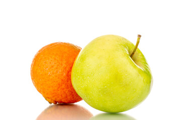 One juicy green apple and tangerine, close-up, isolated on white.