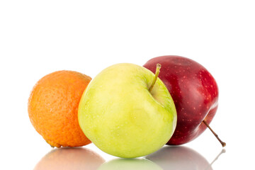 Two juicy apples, green, red and one tangerine close-up, isolated on white.