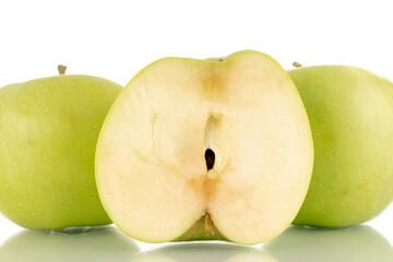 One half and two whole sweet green apples on a clay dish, close-up, isolated on white.