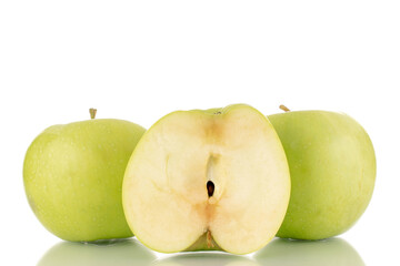 One half and two whole sweet green apples on a clay dish, close-up, isolated on white.