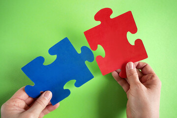 one puzzle connects to other puzzles, a puzzle in the hand of a businessman, a business team puts...