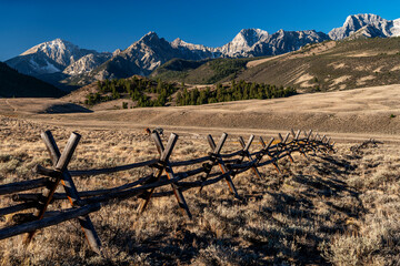 Fototapeta na wymiar Agriculture fence leads to the Lost River range mountains of Idaho
