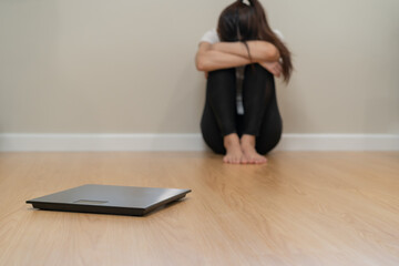 Depressed and stress, sad asian young woman,girl cover face with hand, sitting on floor, weighing...