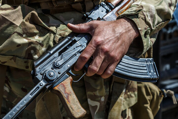 Hands and chests of soldiers in uniforms with machine guns.mashine gun ak - 47 - kalashnikov - Powered by Adobe
