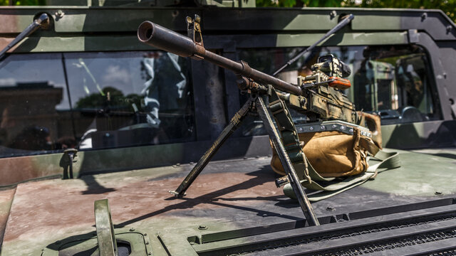 Machine gun Kalashnikov on the tripod and optical sight.M249 light machine gun with 7.62 mm cartridge belt.Military action in the world.