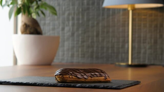 Portrait of a delicious eclair covered with chocolate glaze