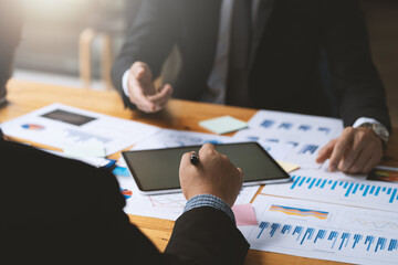 Business people meeting explaining the financial graph data and marketing plan. Group of business...