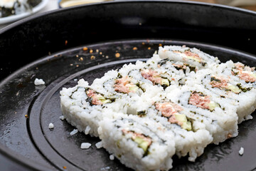 Sushi covered with rice on a baking dish, Japanese food.