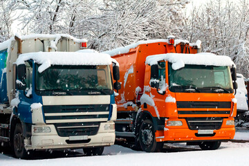 Trucks in the snow. Freezing. Snowfall. Transport.