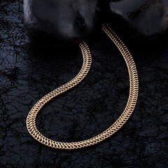 Gold jewelry. Gold chains on black background