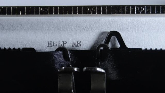 Typing HELP ME with an old manual typewriter