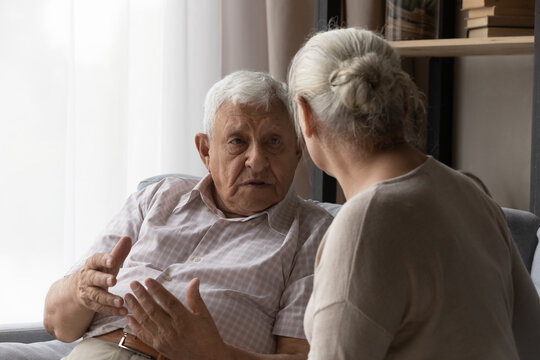 Stressed Old Mature 80s Man Sharing Problems With Compassionate Elderly Wife, Discussing Life Issues Together At Home. Worrying Senior Retired Family Couple Giving Psychological Support And Care.