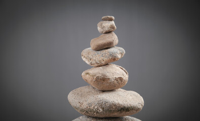 Fototapeta na wymiar Balance stones on grey background.