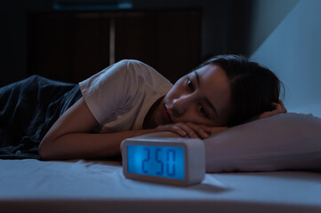 Young Asian woman suffer from insomnia can't sleep at night awaken from stress mental health problem or migraine. Young people health care psychiatry concept. - obrazy, fototapety, plakaty