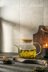 Herbal healthy tea with berries - sea buckthron. Hot fruit drink mix with seaberry or hippophae rhamnoides, fragrant herbs with steam and beautiful light on textured table. Diet detox concept