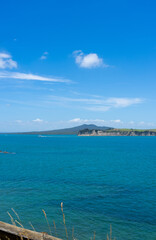 View across Hauraki Gulf from Motuihe Island to volcanic cone of Rangitoto Island New Zealand