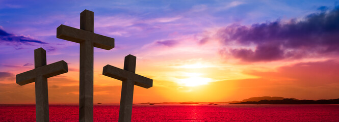 Crucifixion of Jesus Christ.  Silhouette of three crosses against sunset sky.