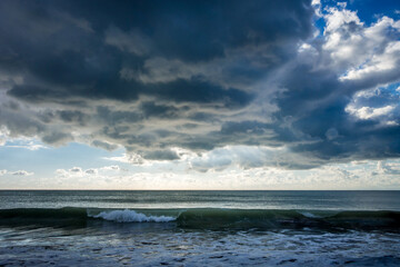 Cloudy seascape view from a beach at sunset