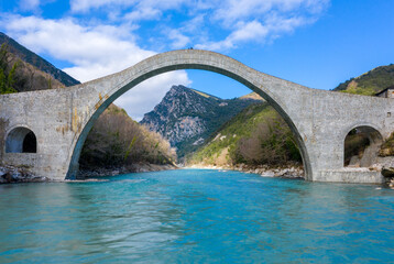 The great arched stone bridge of Plaka on Arachthos river, Tzoumerka, Greece.