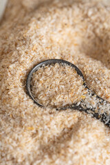 Psyllium husk close up background soluble fiber supplement on white background. Superfood for healthy, lowers cholesterol, balances blood sugar, boosts weight loss. Keto, paleo low carb diet