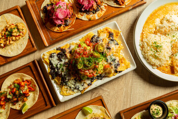Table with assorted Mexican food as seen from above.