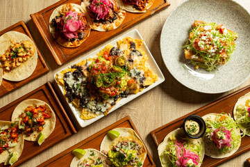 Table with assorted Mexican food as seen from above.