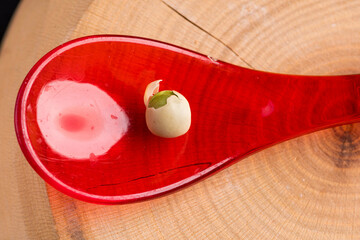 red spoon with dry pea