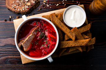 Red borscht beetroot with pork ribs. Festive table with delicious food.