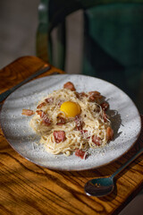 Pasta spaghetti carbonara with egg. Italian cuisine.