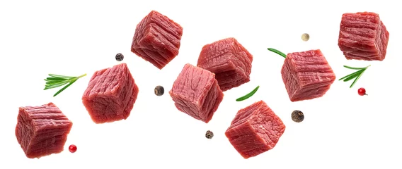 Fotobehang Cubes of raw beef meat isolated on white background © xamtiw